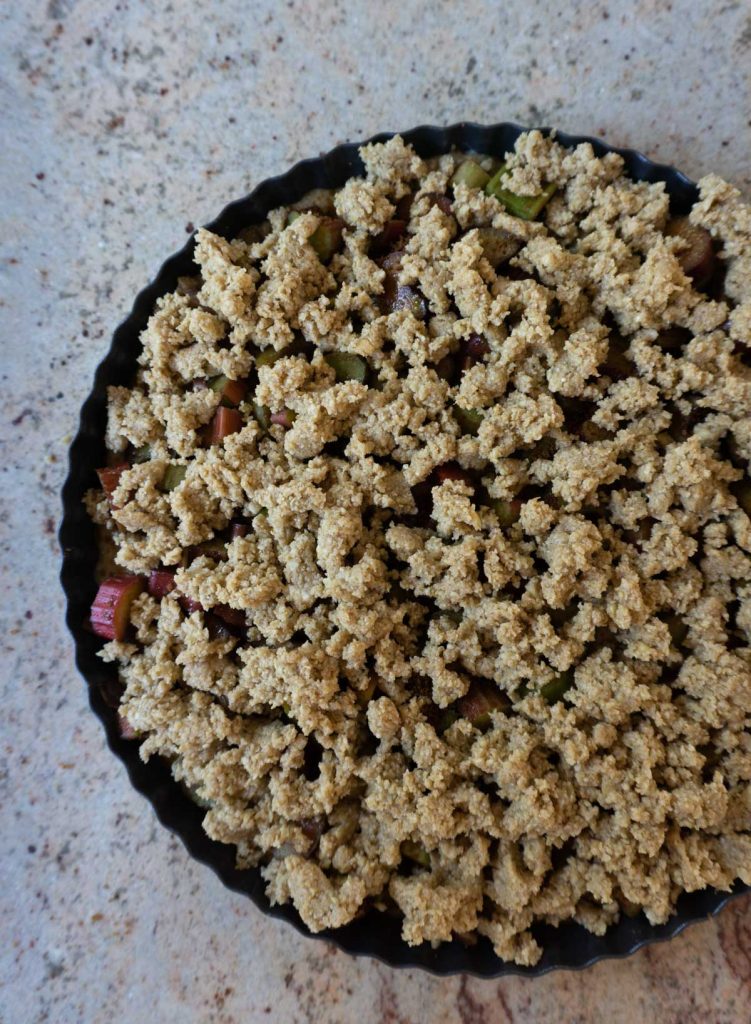Crumble on top of rhubarb streusel cake before baking