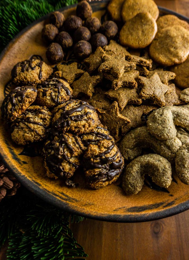 Orange chocolate macaroons on a plate with other cookies