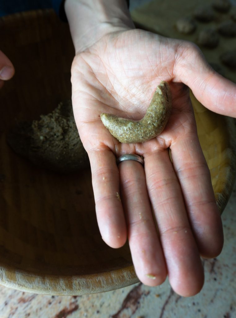Vanilla crescent cookie formed in hand