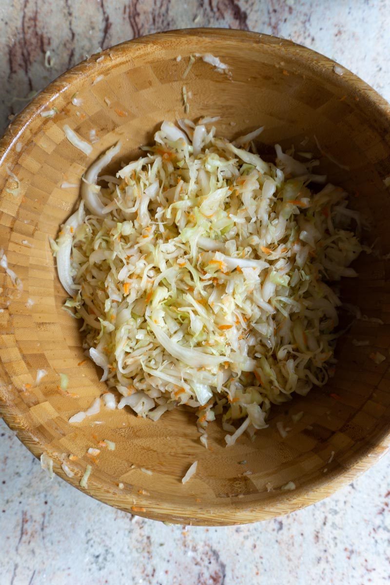 Massaging cabbage, fennel seeds, salt, garlic and grated carrot