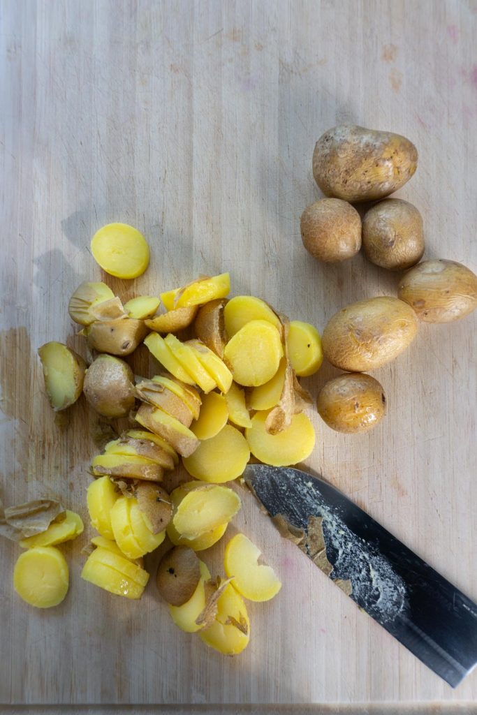 Boiled potatoes cut on a board