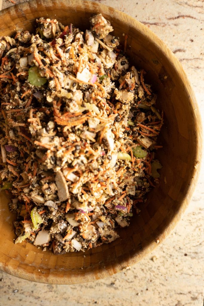 All ingredients for the Lentil Mushroom Walnut "Meat" Loaf mixed through in a wooden salad bowl