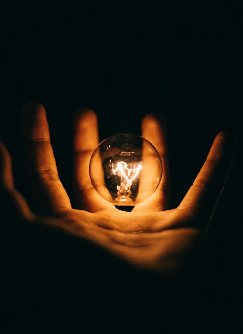 Light bulb fizzing in an open hand