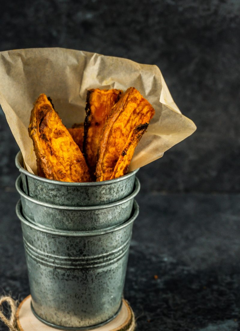 Sweet Potato Wedges in a metal cup being stacked up
