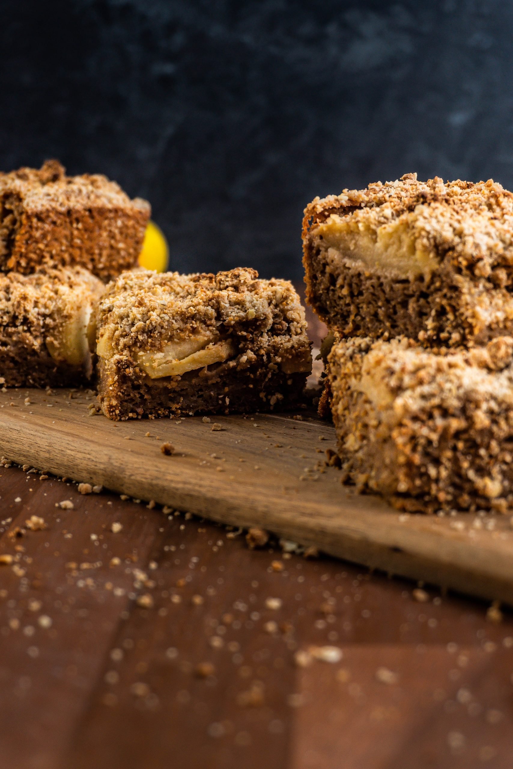 Pieces of Apple Crumble Cake on a wooden platter