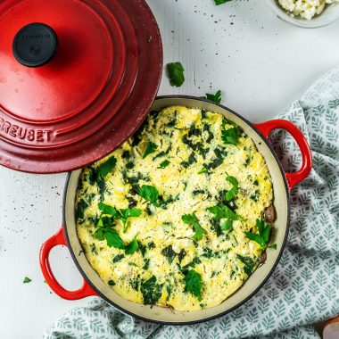 My Everyday Omelette in a pan with parsley strewn on top, and some feta cheese sprinkled throughout