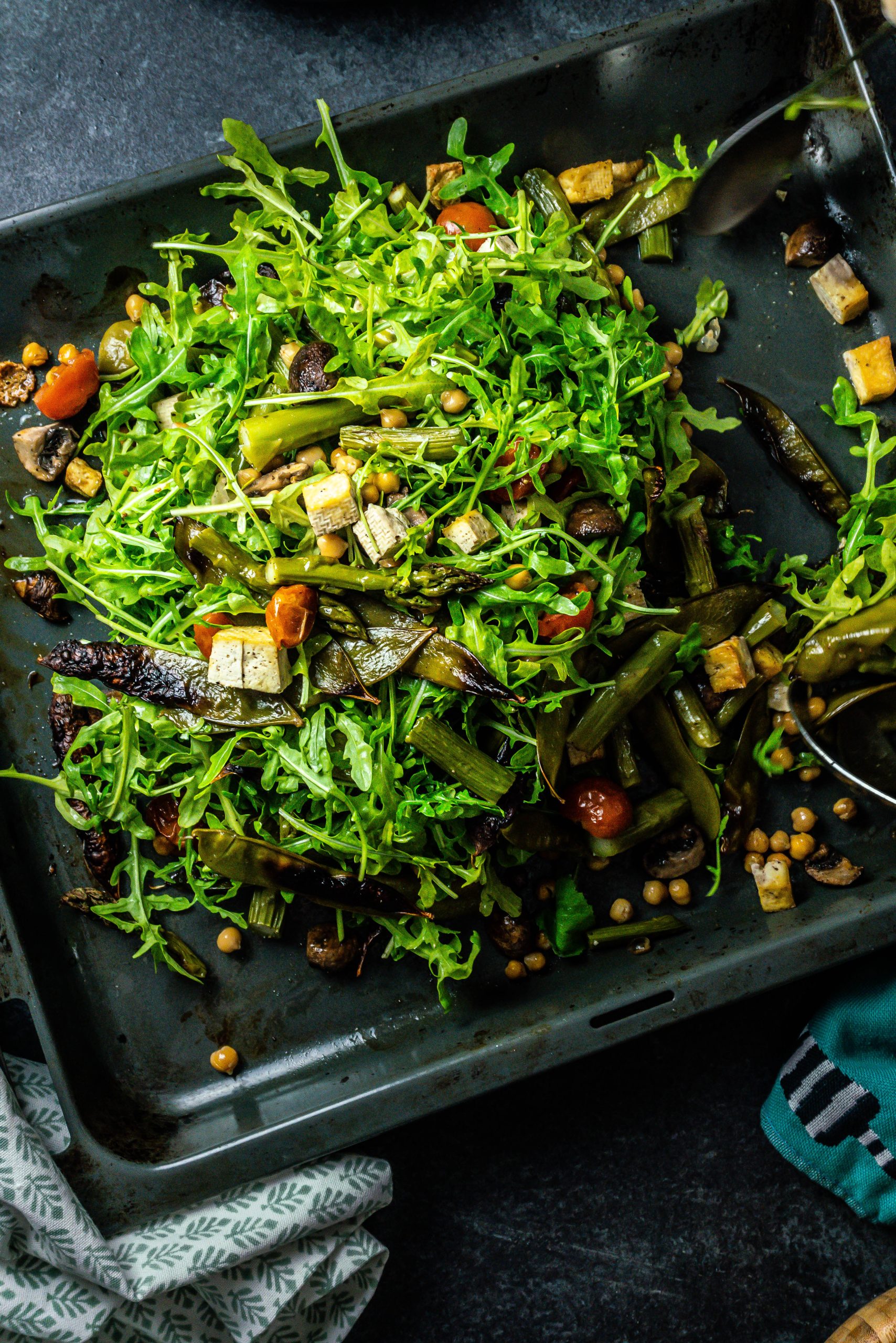 Spring Greens Oven Tray Bake mixed through on a tray