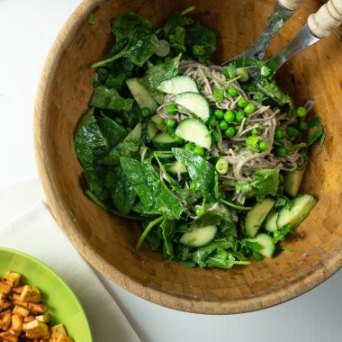 Soba noodles, spinach, cucumber, peas, spring onions, and cilantro are coated in a dressing for this Perfect Soba Noodle Salad