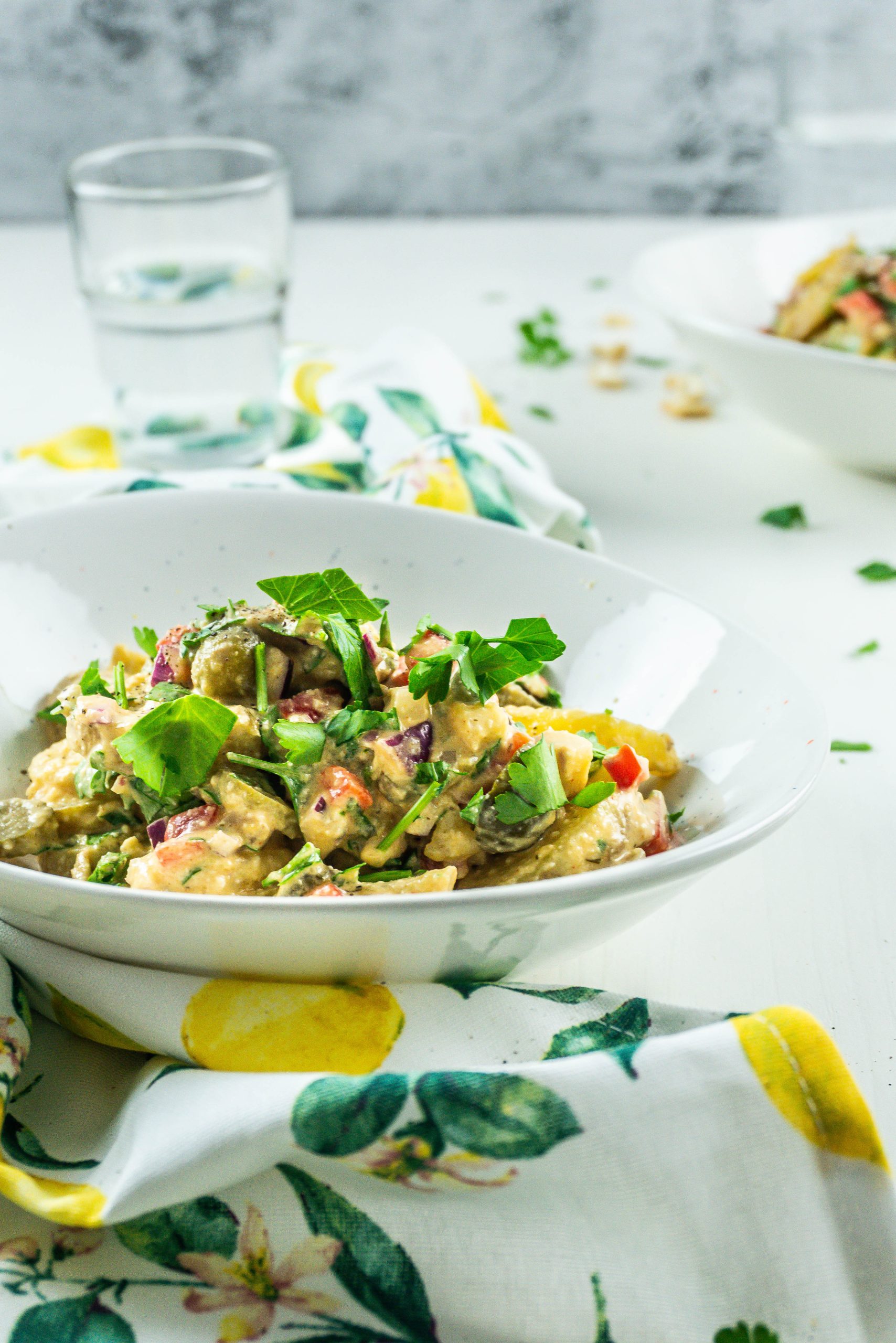 Vegan Potato Salad in a bowl, ready for serving; photographed from a side-angle