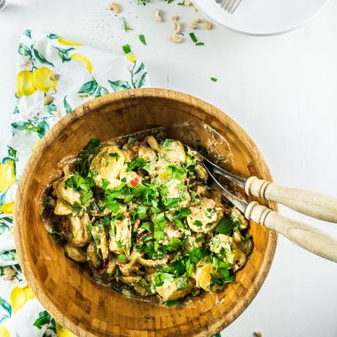 Vegan Potato Salad in a bowl with salad tongs on the side
