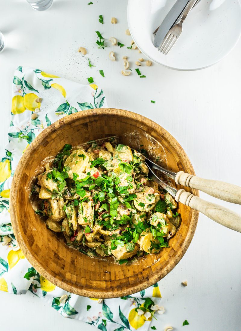 Vegan Potato Salad in a bowl with salad tongs on the side