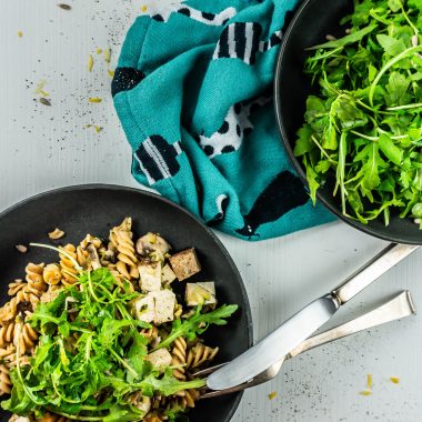 15-Minute Summer Pasta on a plate with a fork and knife resting on the plate; photographed from above