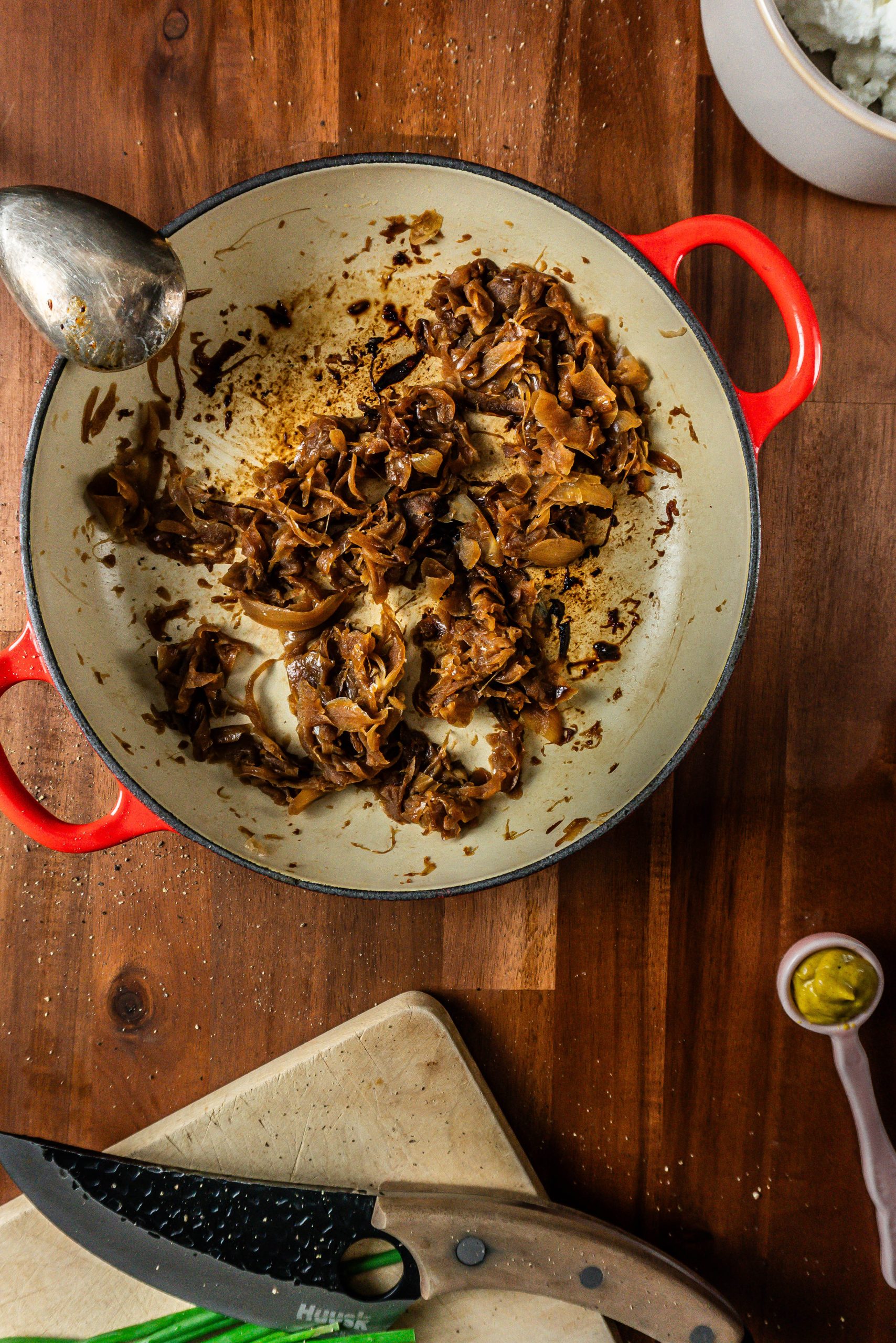 Caramelized onions in a non-sticking pan that have been rendered down