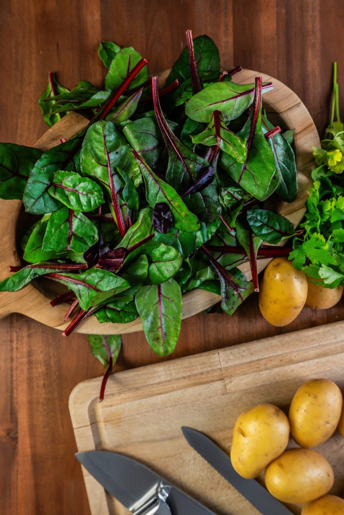 Young swiss chard in a wooden bowl