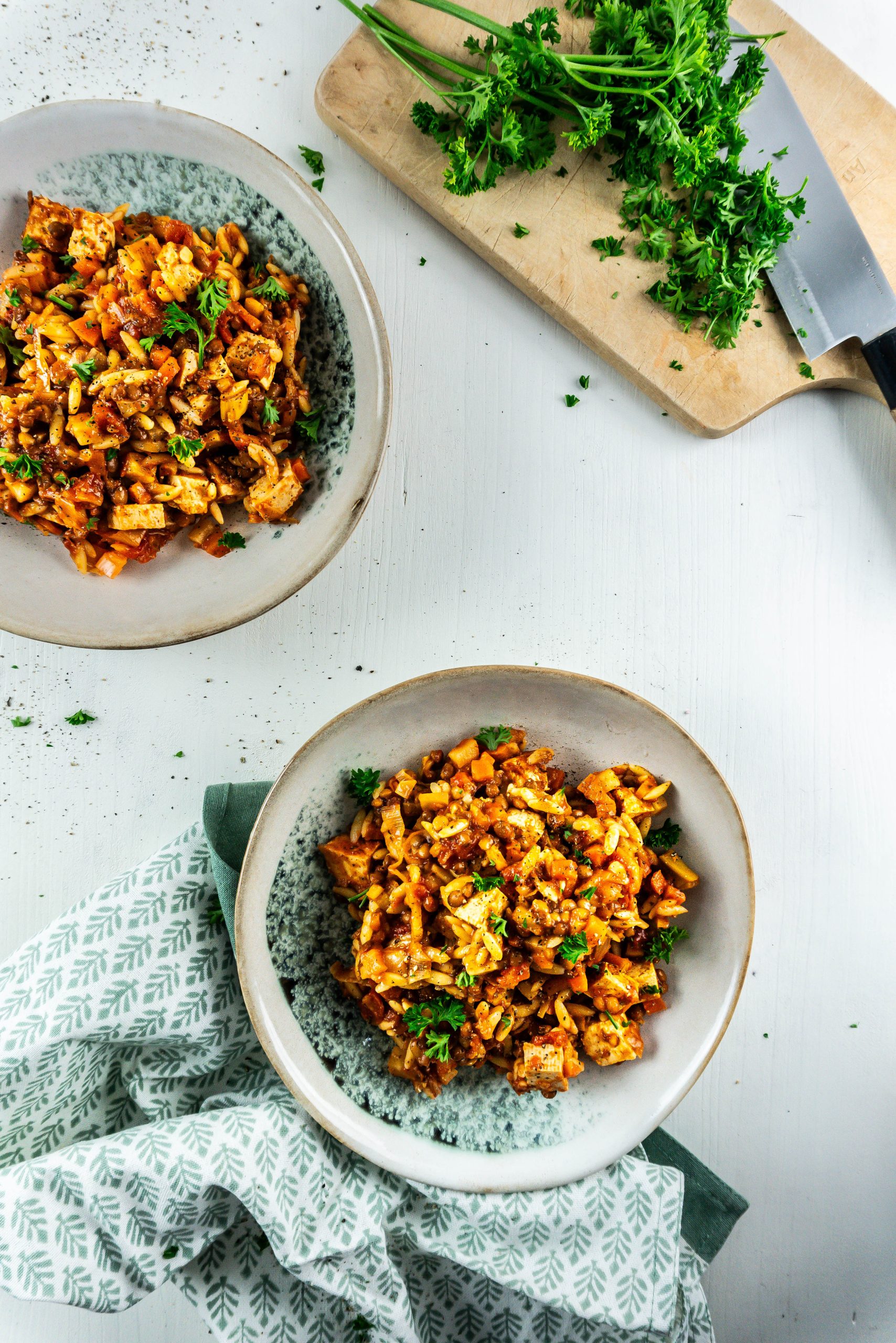 Comforting Tomato Noodle Soup on two plates with some parsley strewn about