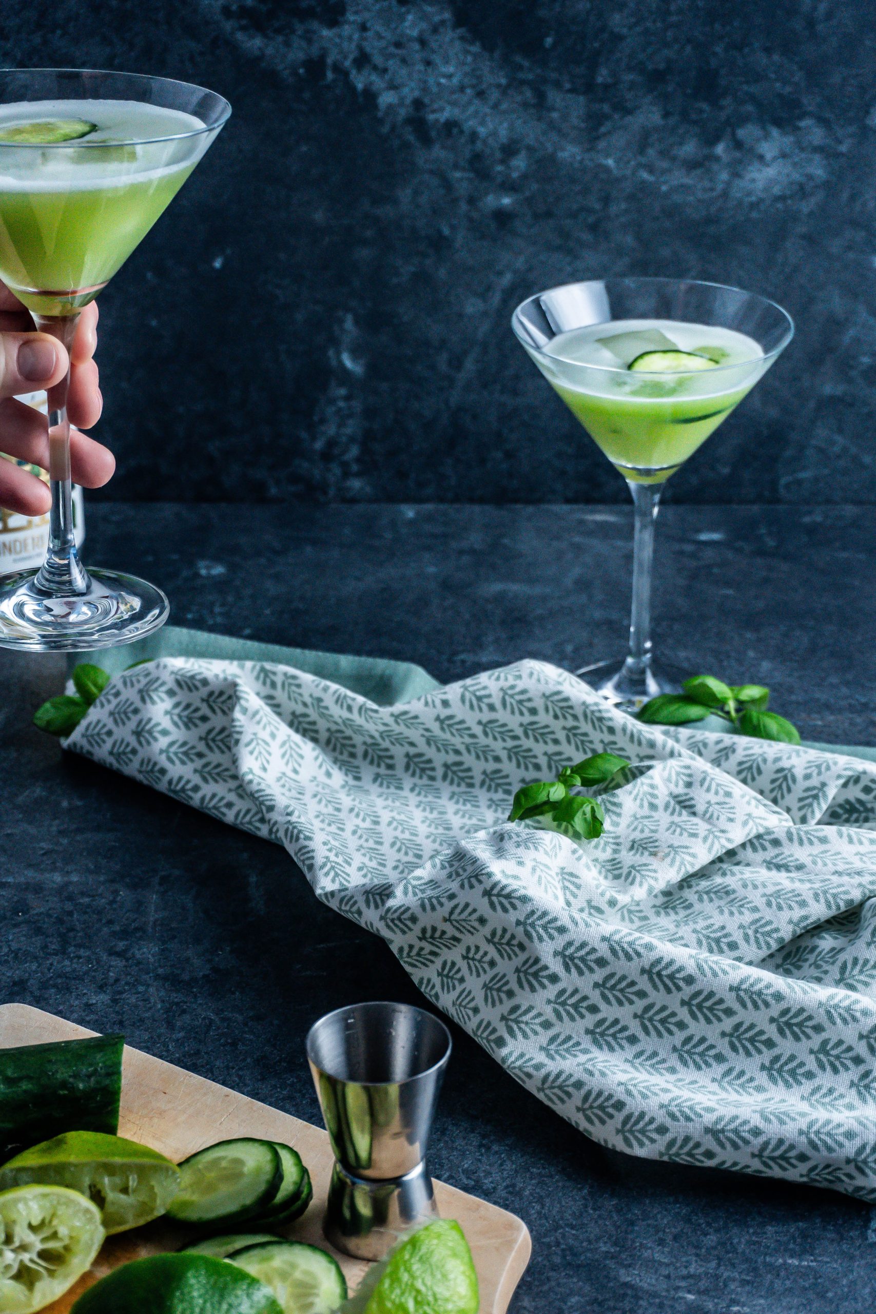 non-alcoholic garden sour cocktail being picked up ready for drinking and being dragged out of the picture