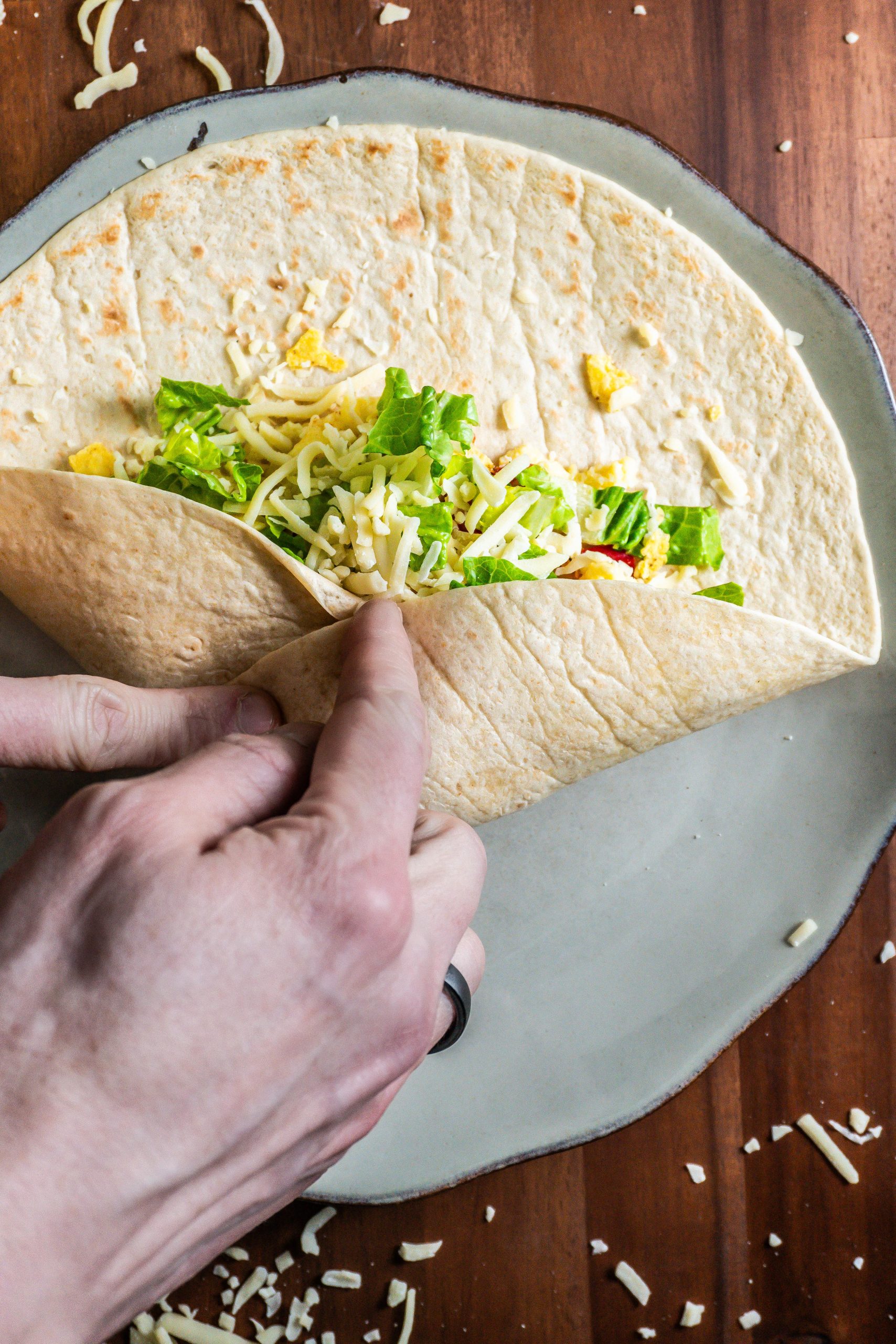 15-Minute Vegetarian Lunch Crunch Wrap being folded in order to be baked