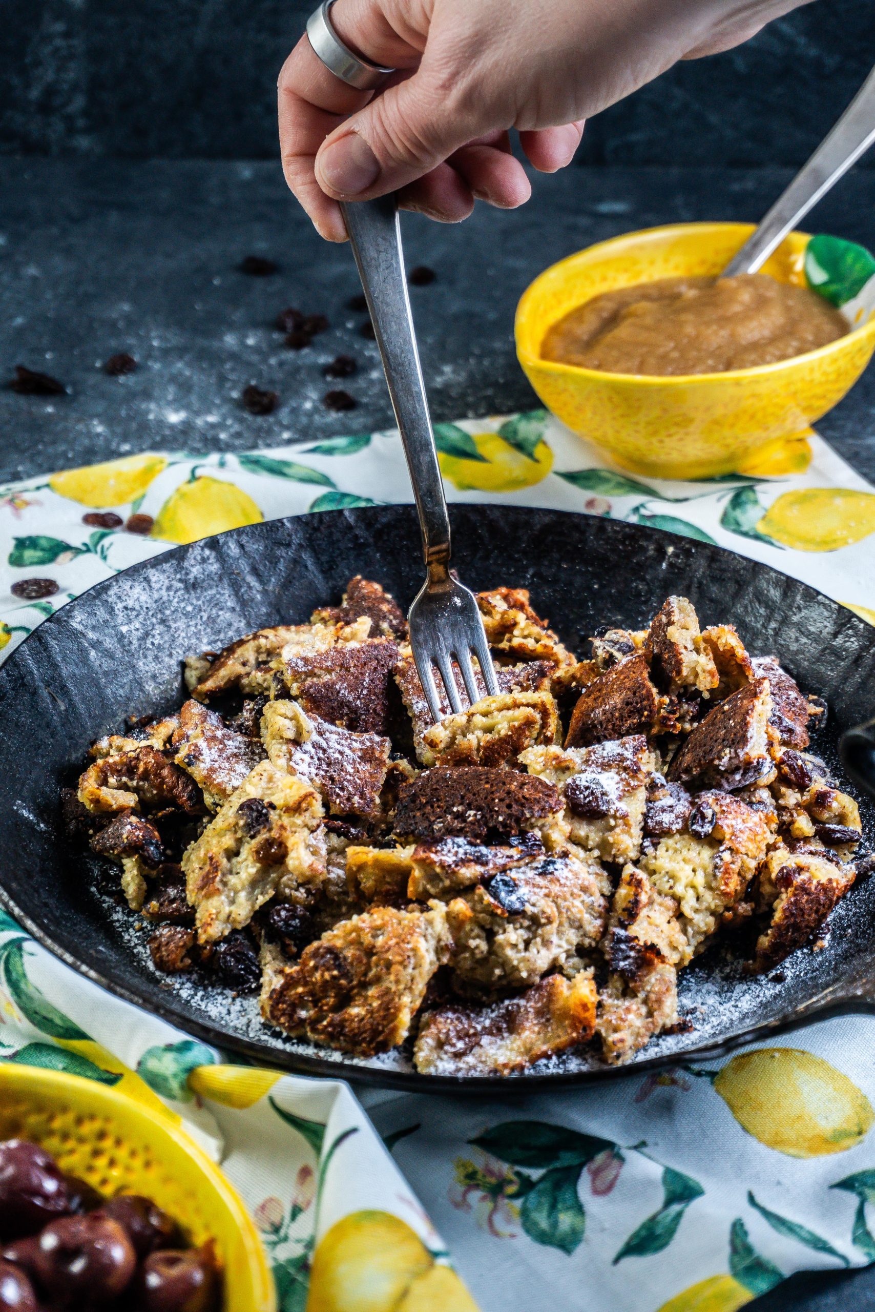 Gluten-free Kaiserschmarrn in a cast iron skillet with a fork being tugged into it