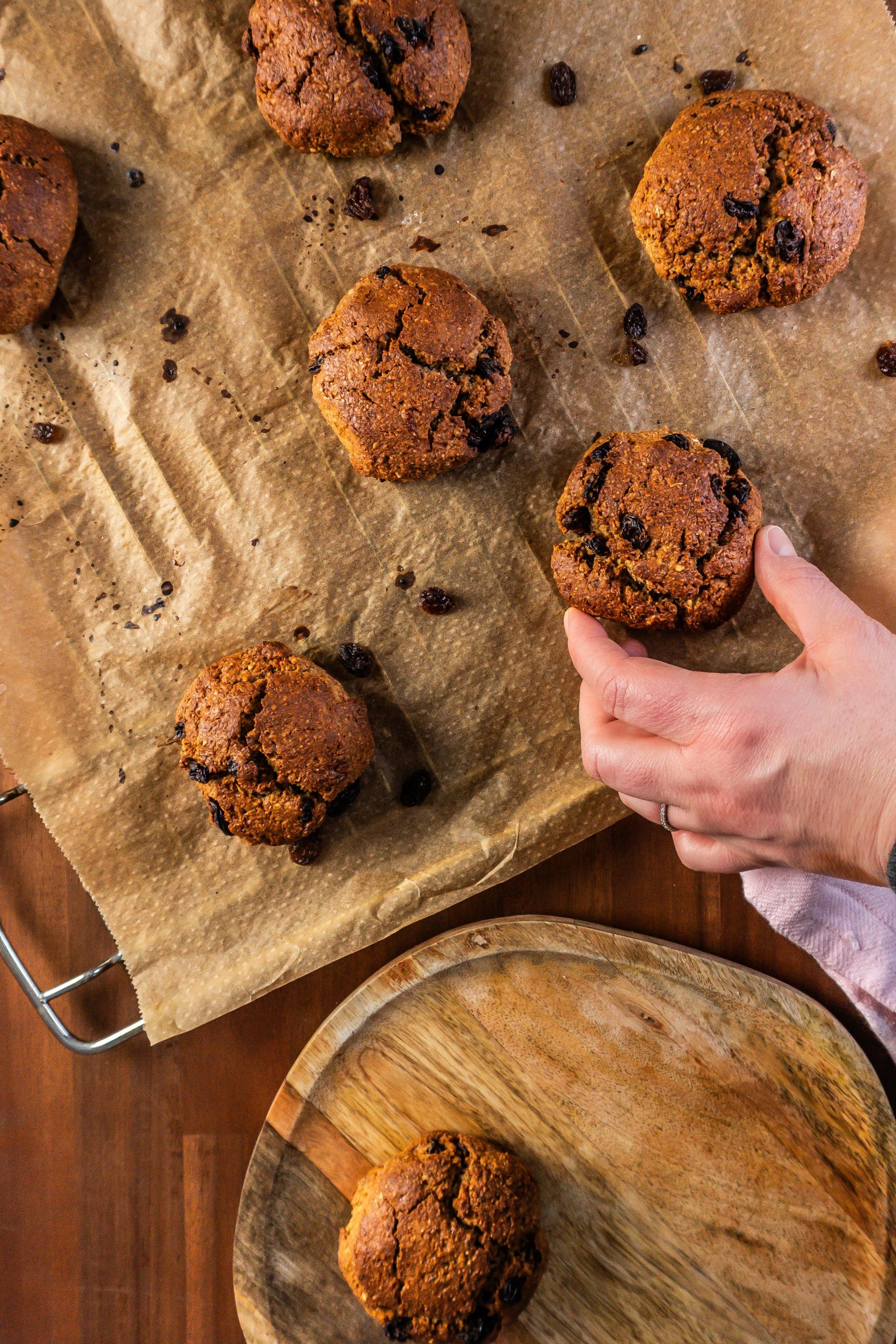 Cinnamon Orange Raisin Scones on a baking tray being transferred and arranged on a platter