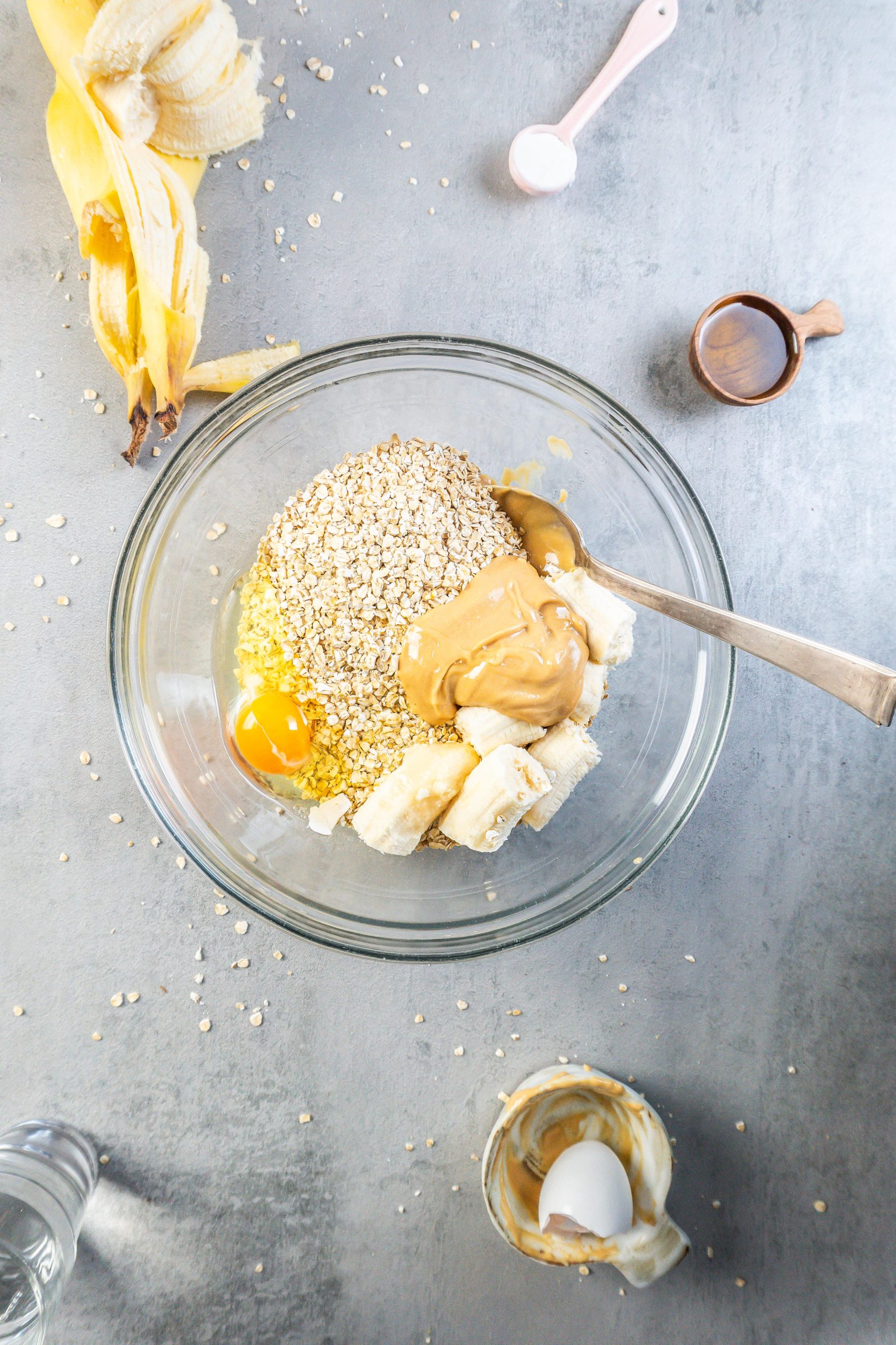 Oats, peanut butter, banana, and an egg in a bowl
