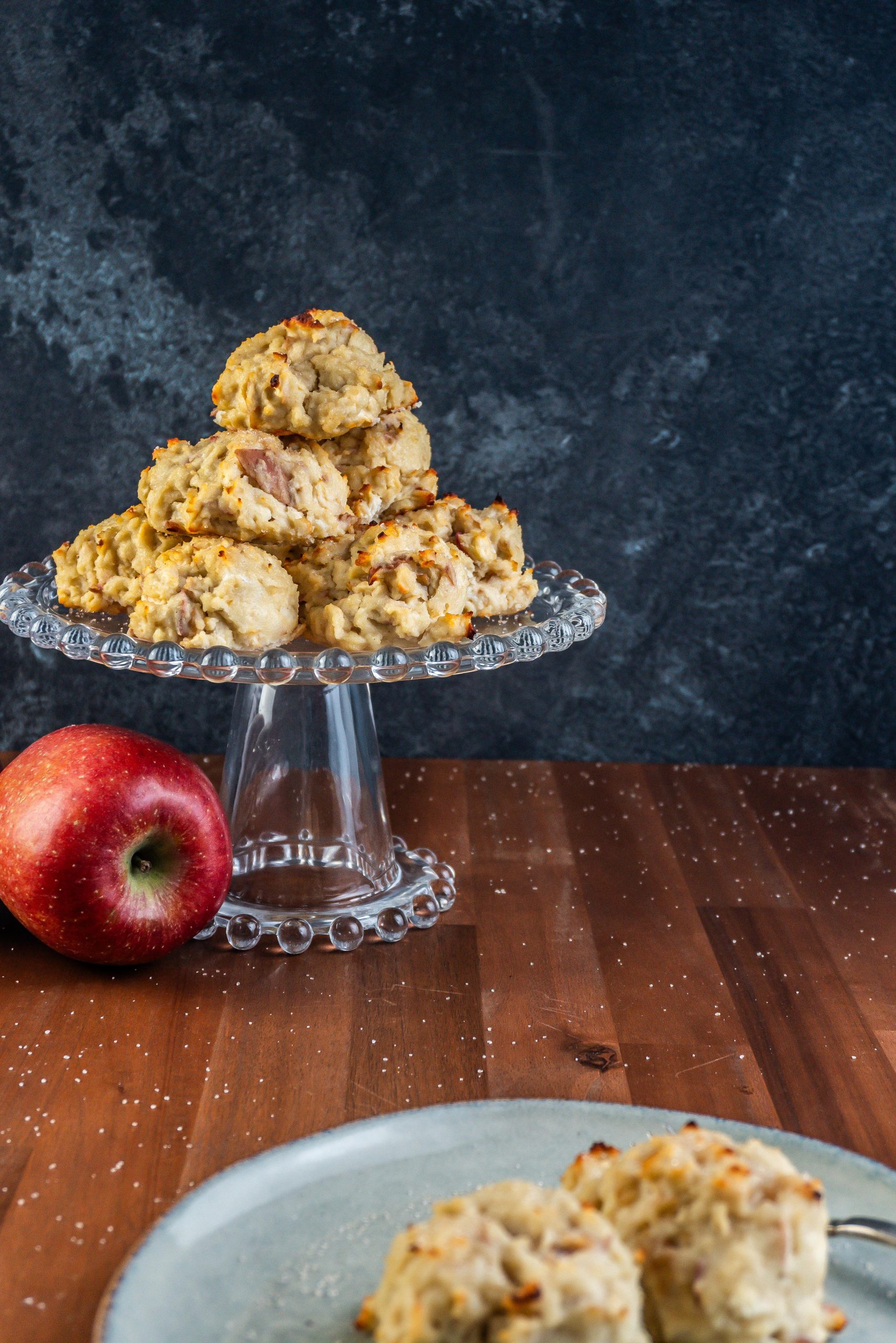 Mini Apple Quark Balls on a cake stand with an apple laying to the side