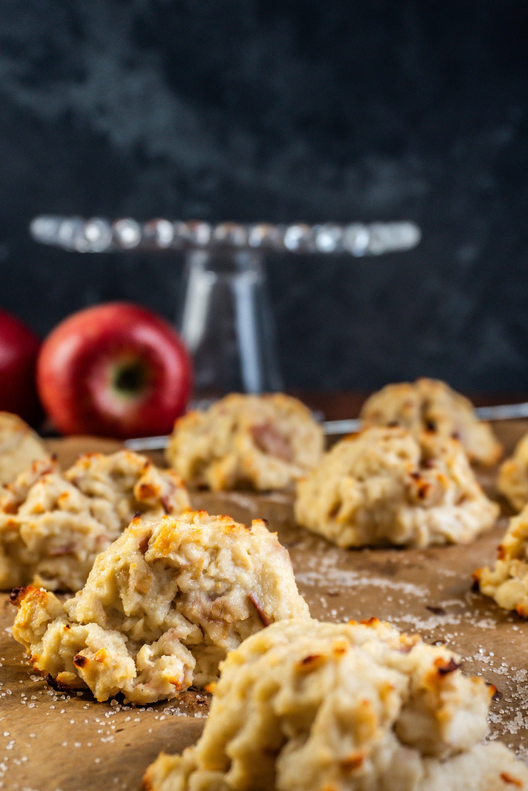 Mini Apple Quark Balls on a baking tray with one specific one in focus; photographed from a side-angle
