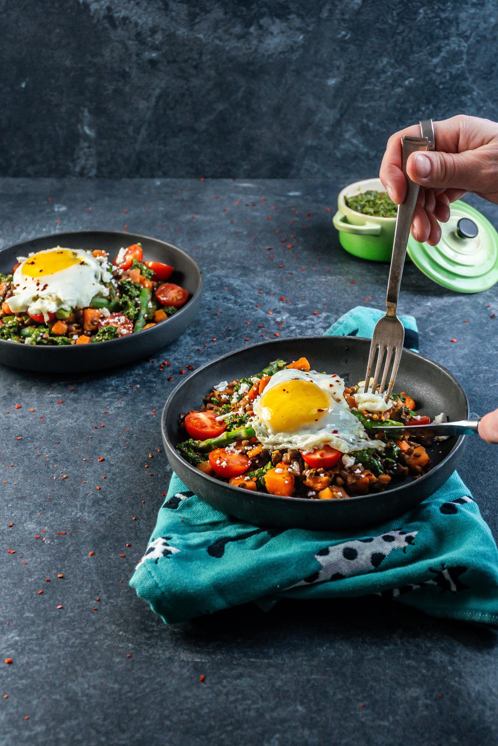 Knife and fork being tugged into a savory breakfast bowl
