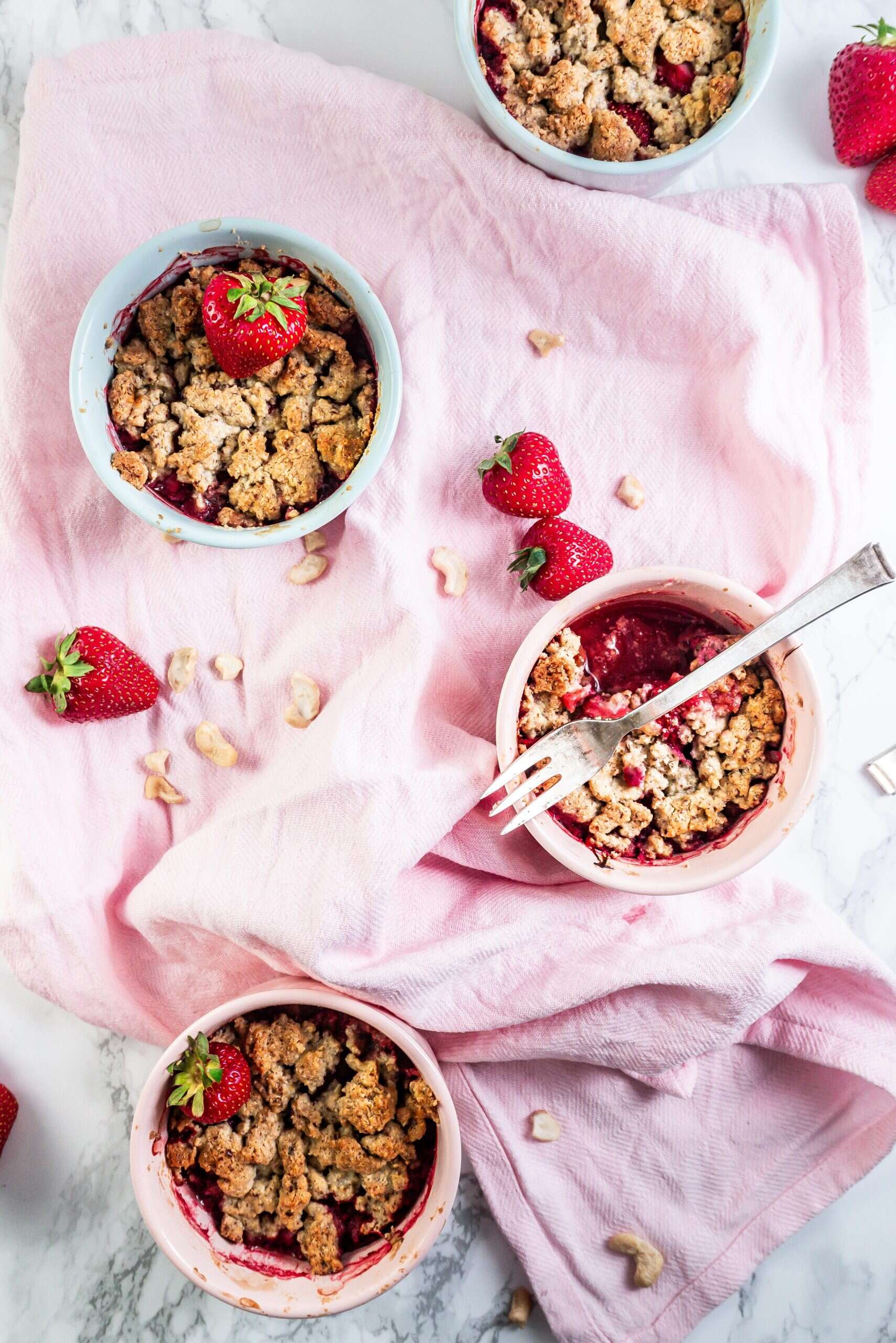 Strawberry Rhubarb Crumble with a fork laying on the ramekin; photographed from above