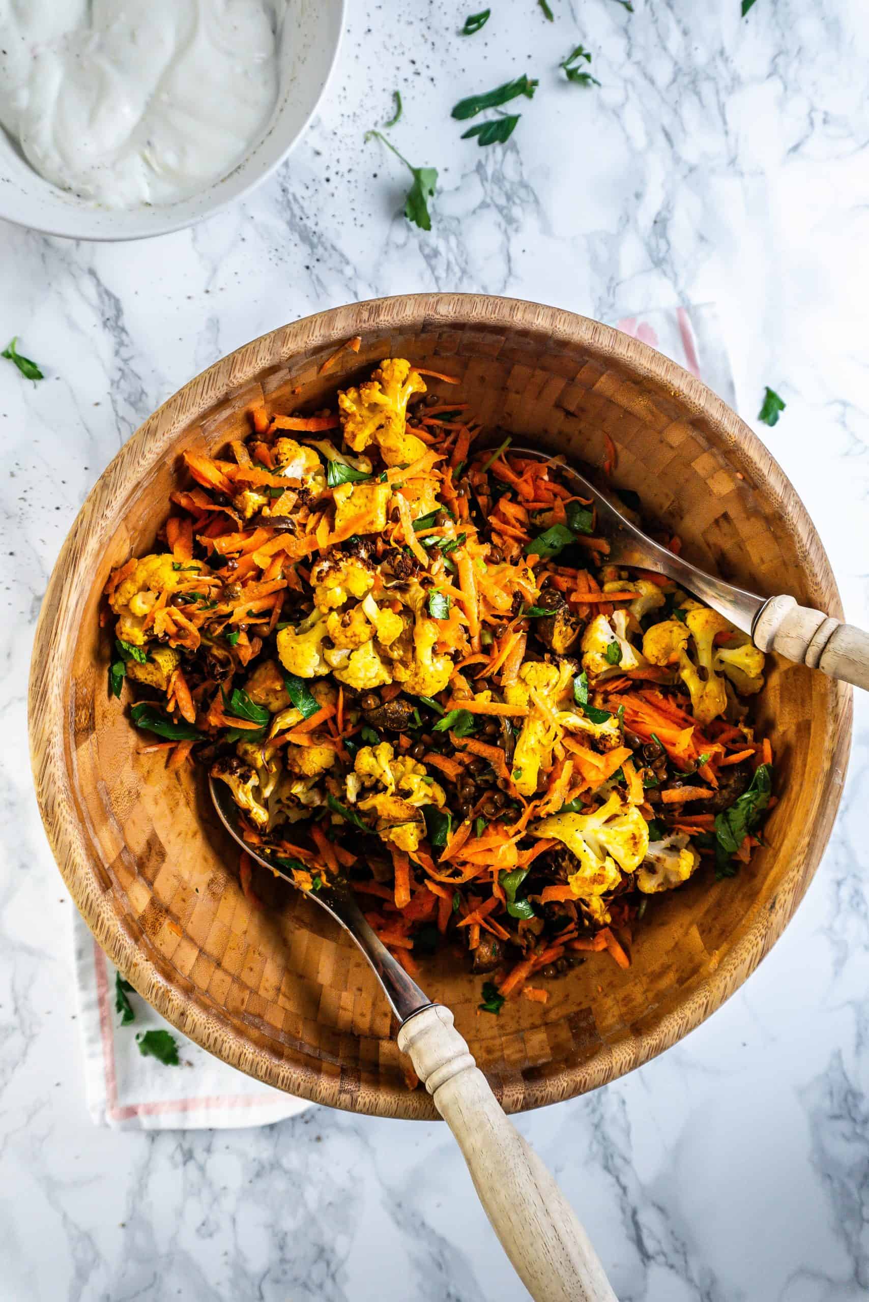 Roasted Cauliflower Salad in a bowl being mixed through
