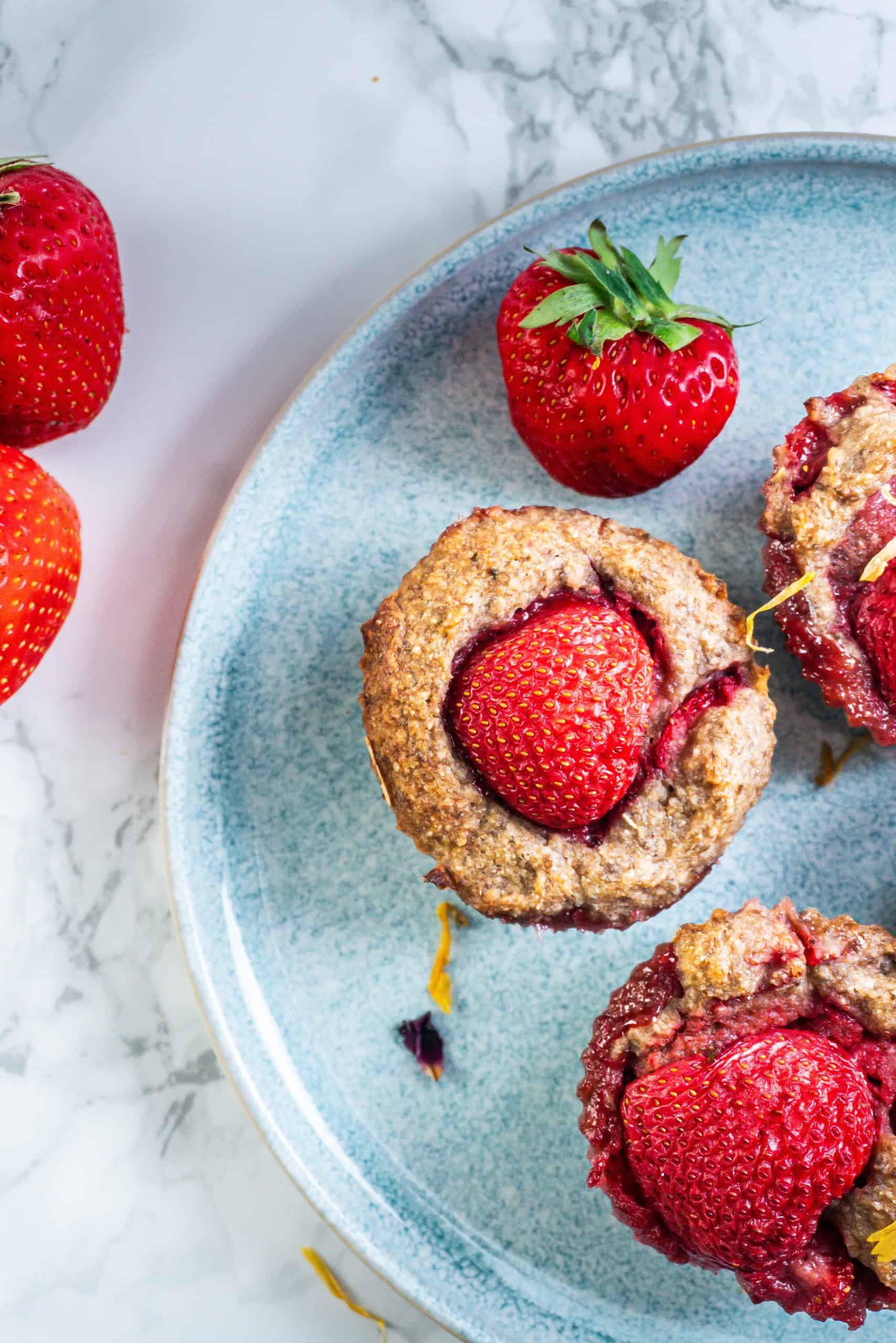 Strawberry Banana Muffins photographed up close on a plate from above
