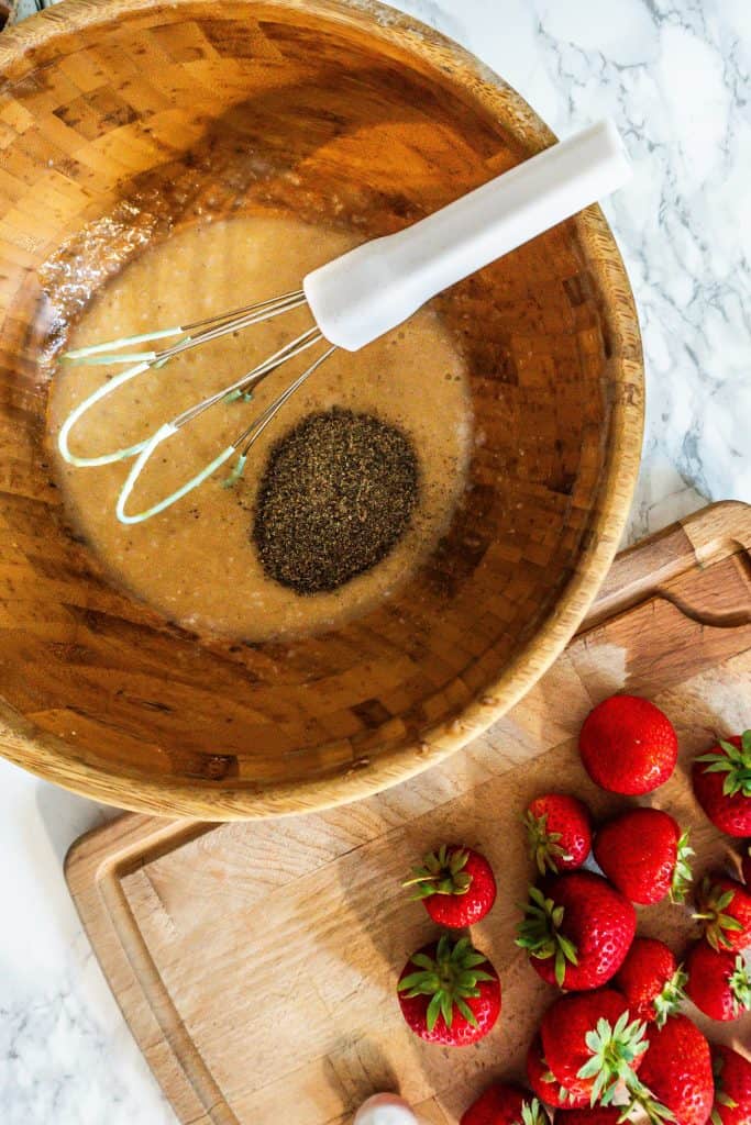 Adding ground chia seeds to the liquid ingredients in the bowl for the Strawberry Banana Muffins