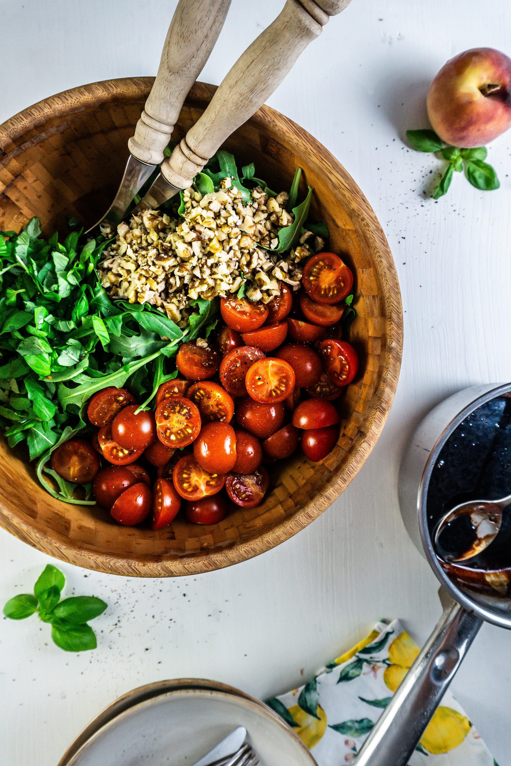 Cherry tomatoes, rocket, basil, and walnuts in a salad bowl