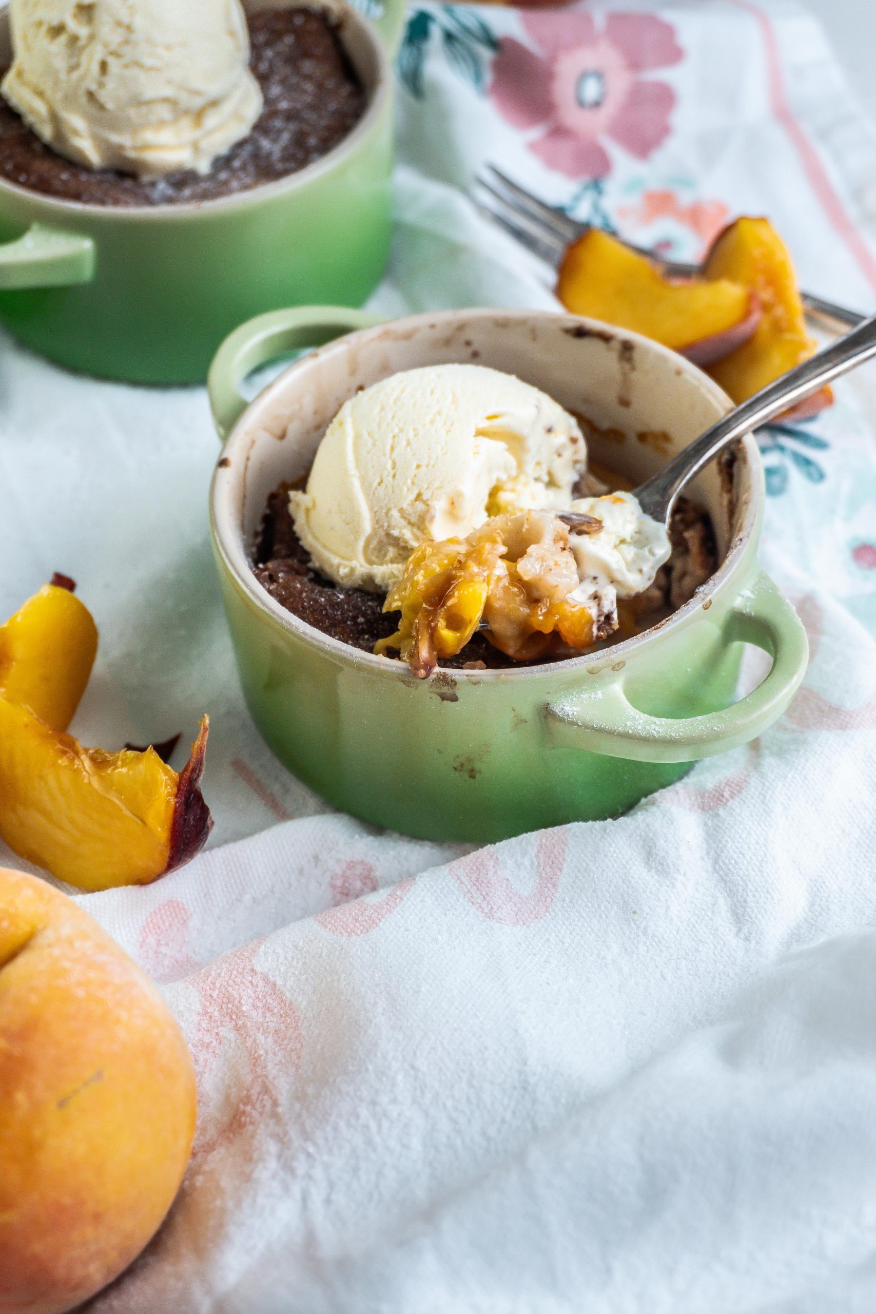Mini Peach Cobller being pulled out of the ramekin dish by a fork