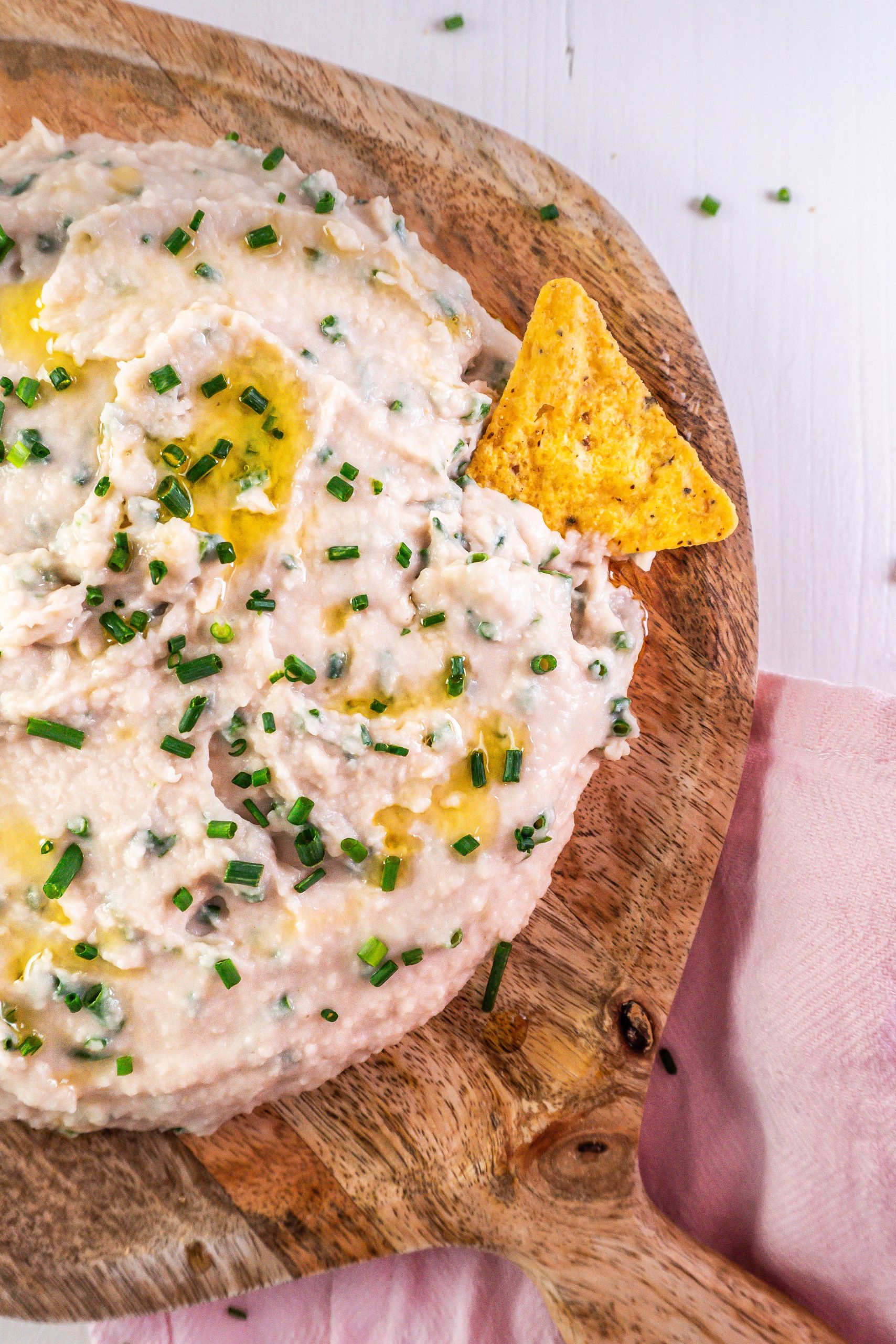 Quick and easy butterbean dip garnished with chives and photographed up close and from a half-angle