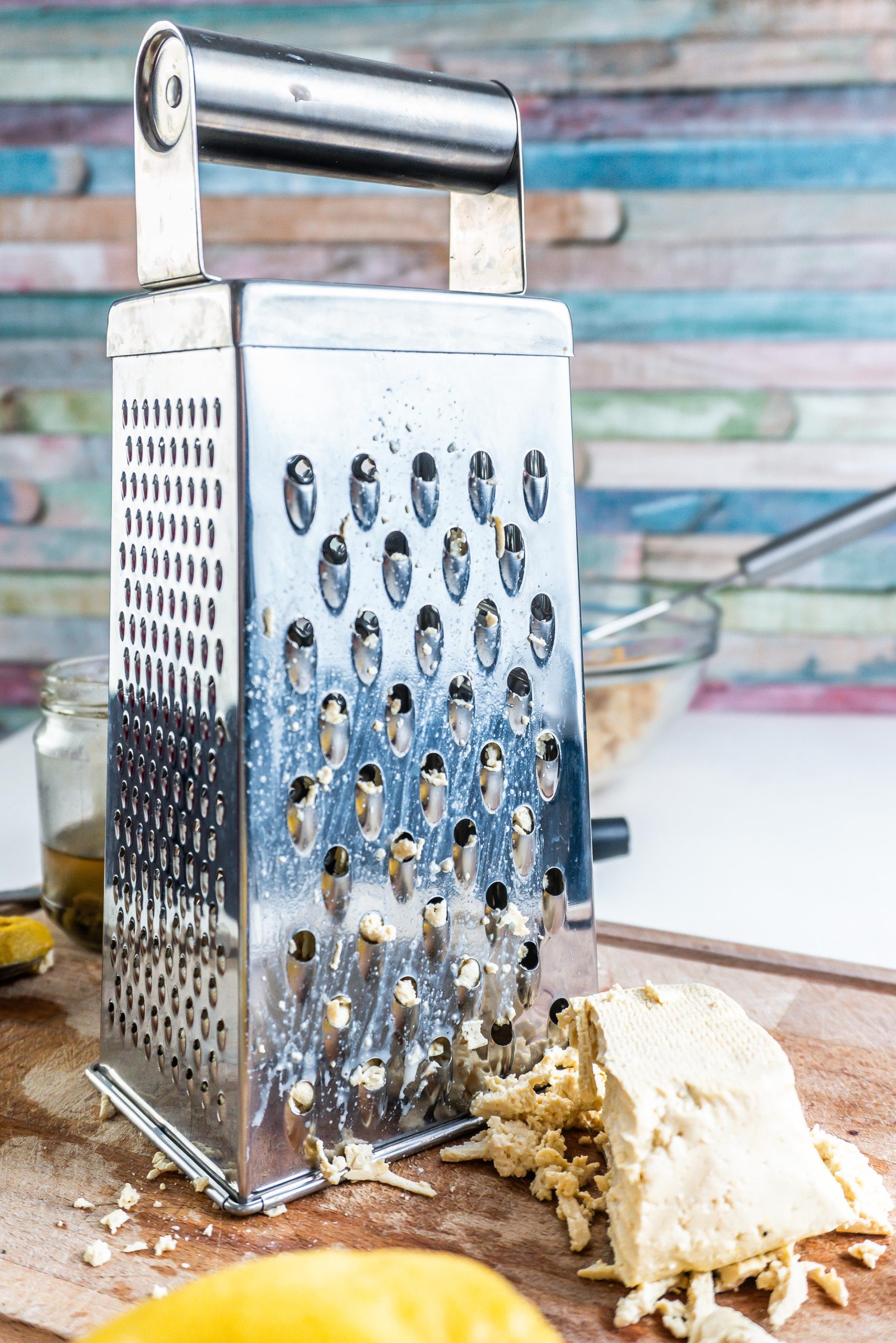Tofu being grated on a chopping board